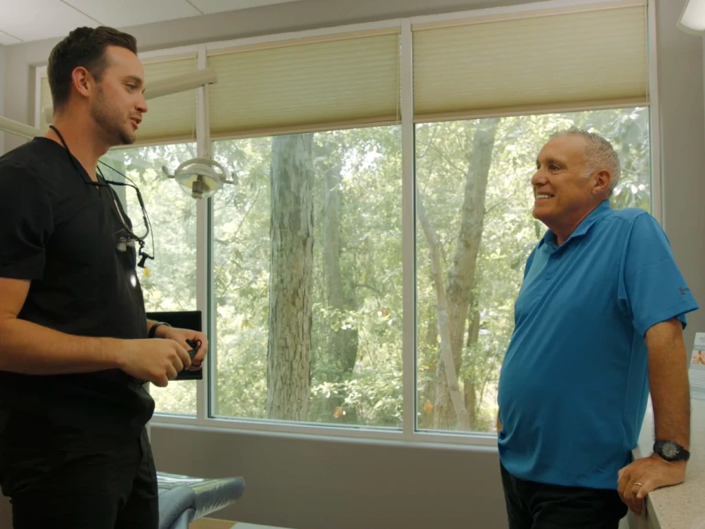Dr. Duerr chatting with a smiling patient | Locally-owned dentist in Wilmington, NC